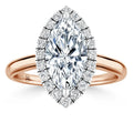 Rose gold ring with marquise-cut diamond center, surrounded by a halo of smaller round diamonds.