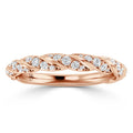 A rose gold ring with a twisted band design, set with small round diamonds along the braided pattern.