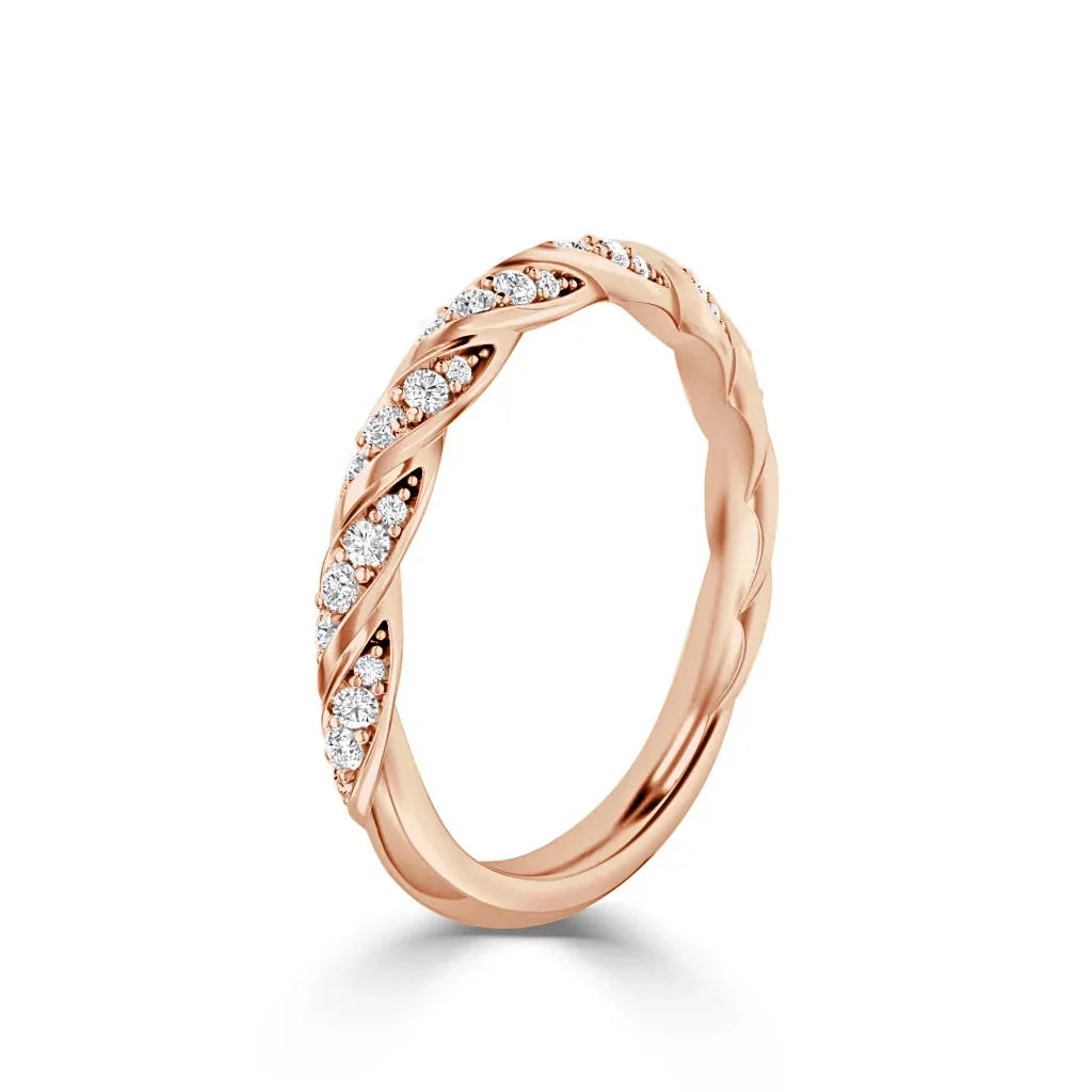 Rose gold ring with twisted band design, featuring embedded round white diamonds on the top half.
