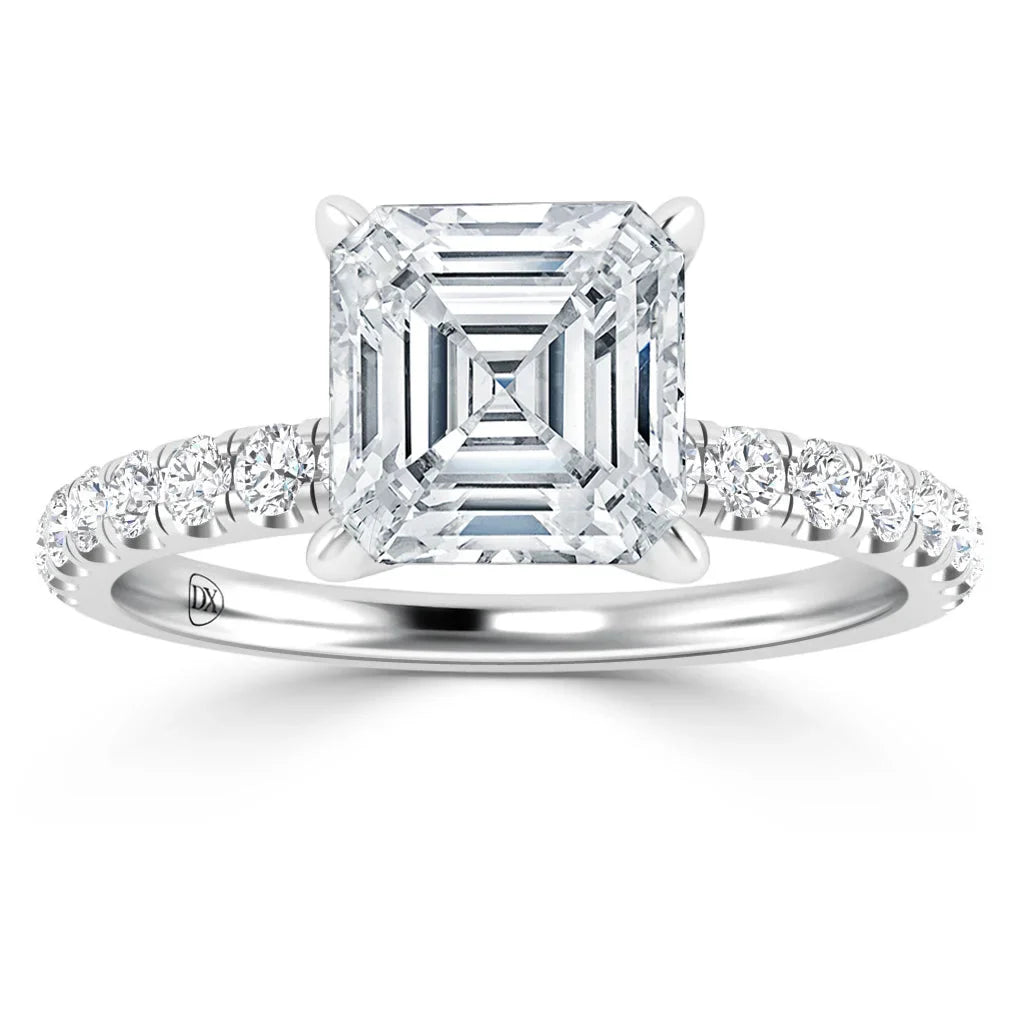 Asscher-cut diamond ring with a pavé band set in white gold, viewed from the front on a white background.