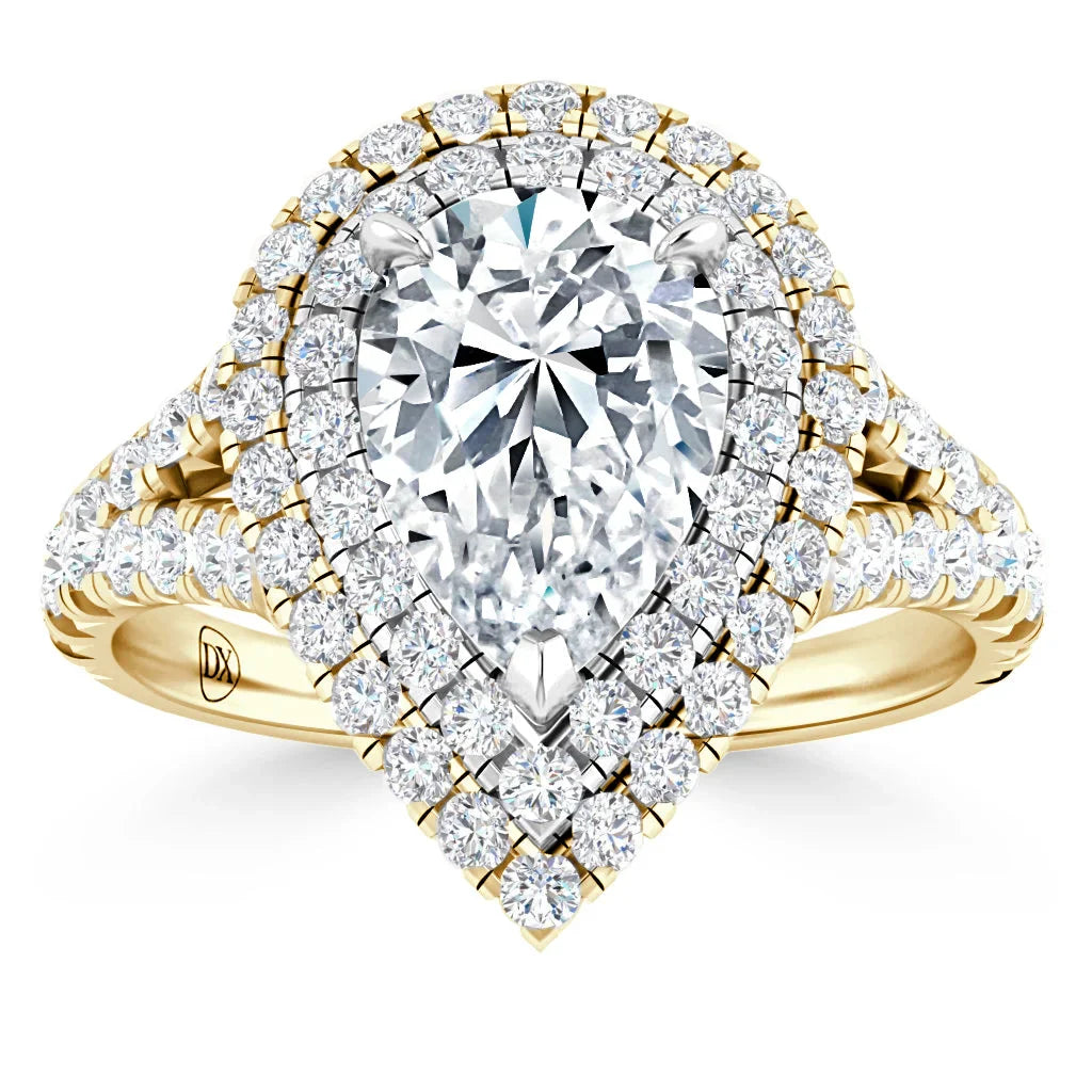 Gold ring with a large pear-shaped diamond, double halo of smaller diamonds, and a split shank band.