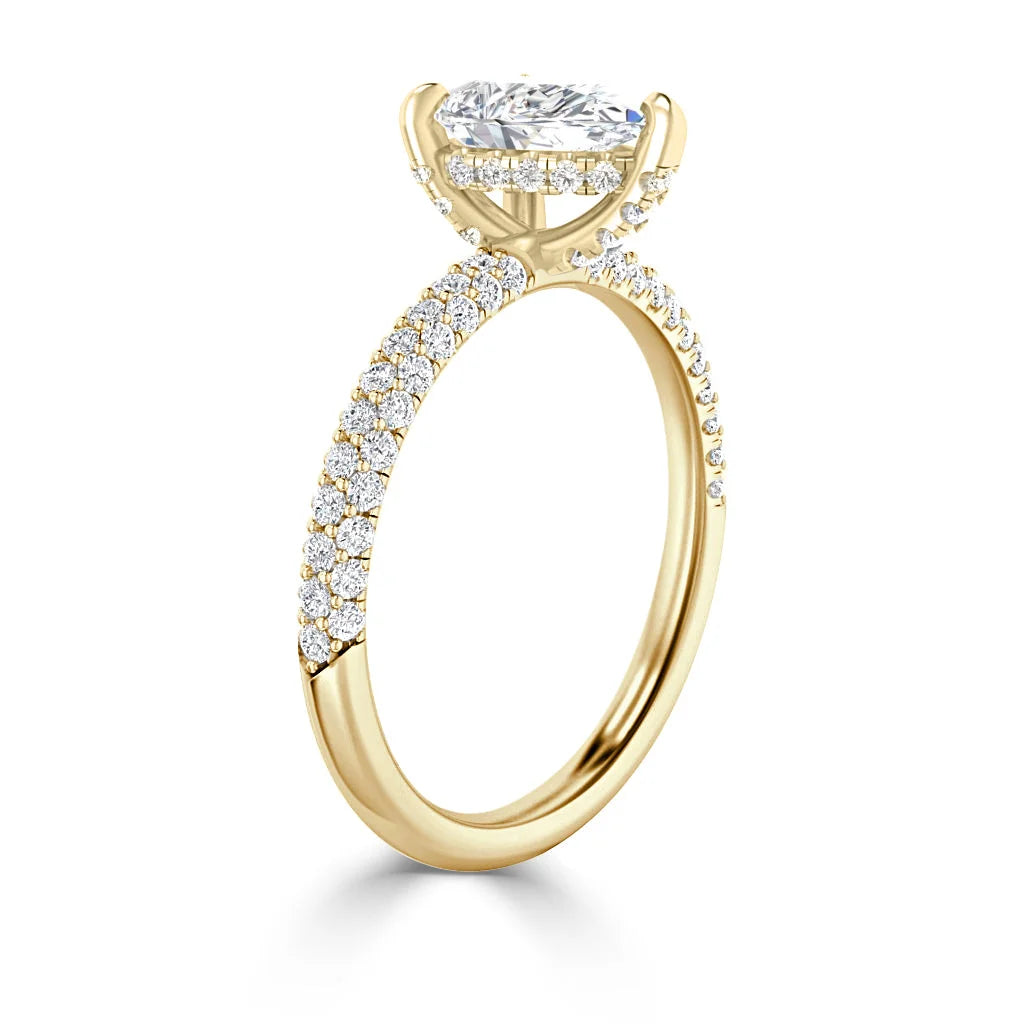Gold engagement ring with pavé-set diamonds and a large oval diamond in a prong setting.