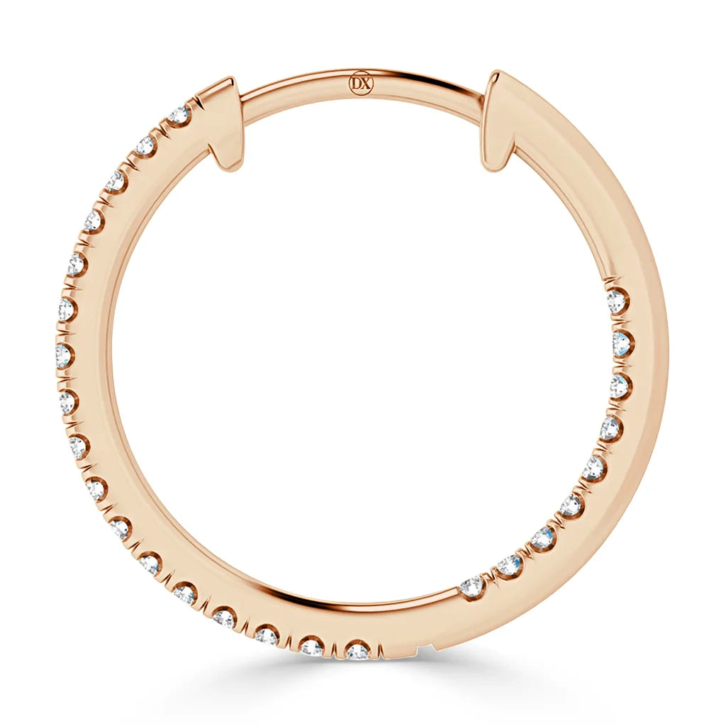 A rose gold hoop earring adorned with small, evenly spaced round diamonds along the outer edge.