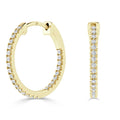 Gold hoop earrings encrusted with small, round diamonds, shown from front and side on a white background.