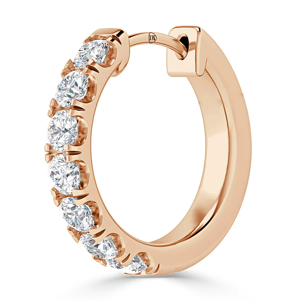 A rose gold hoop earring adorned with round, white sparkling gemstones along the front half.