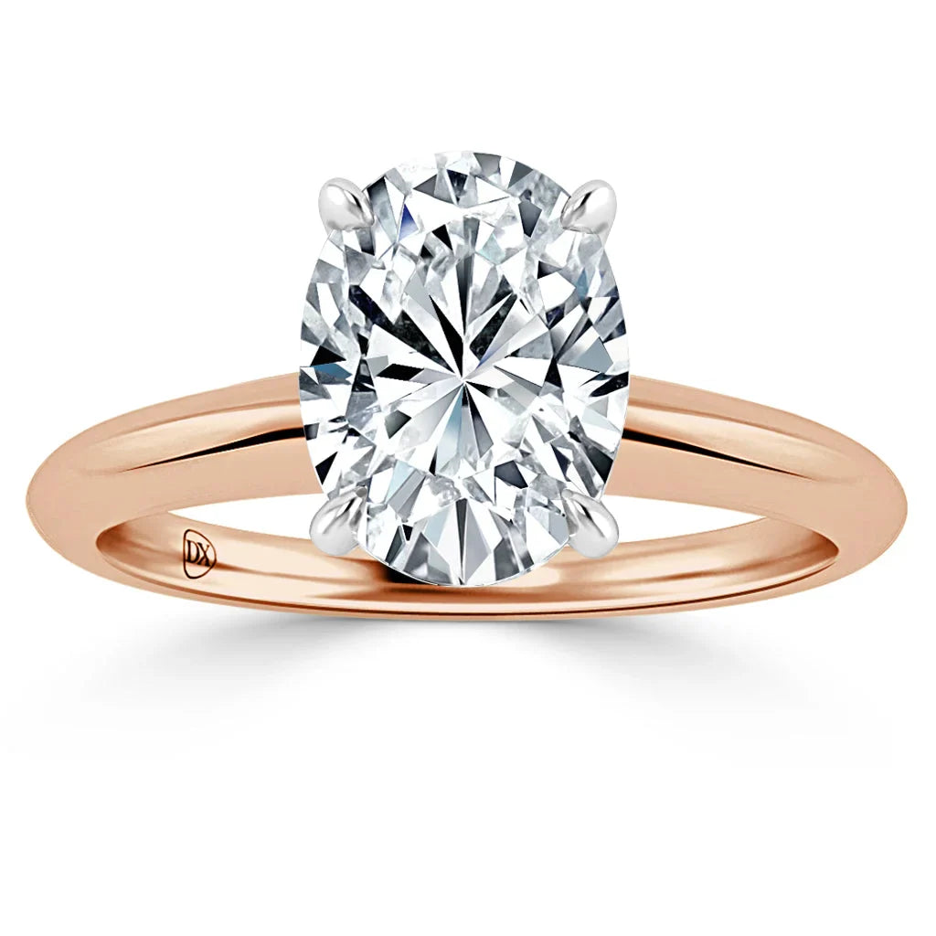 Oval diamond solitaire ring with rose gold band and four prongs, displayed on a white background.
