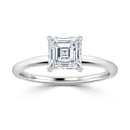 A solitaire ring with an Asscher-cut diamond set on a simple, polished white gold band.
