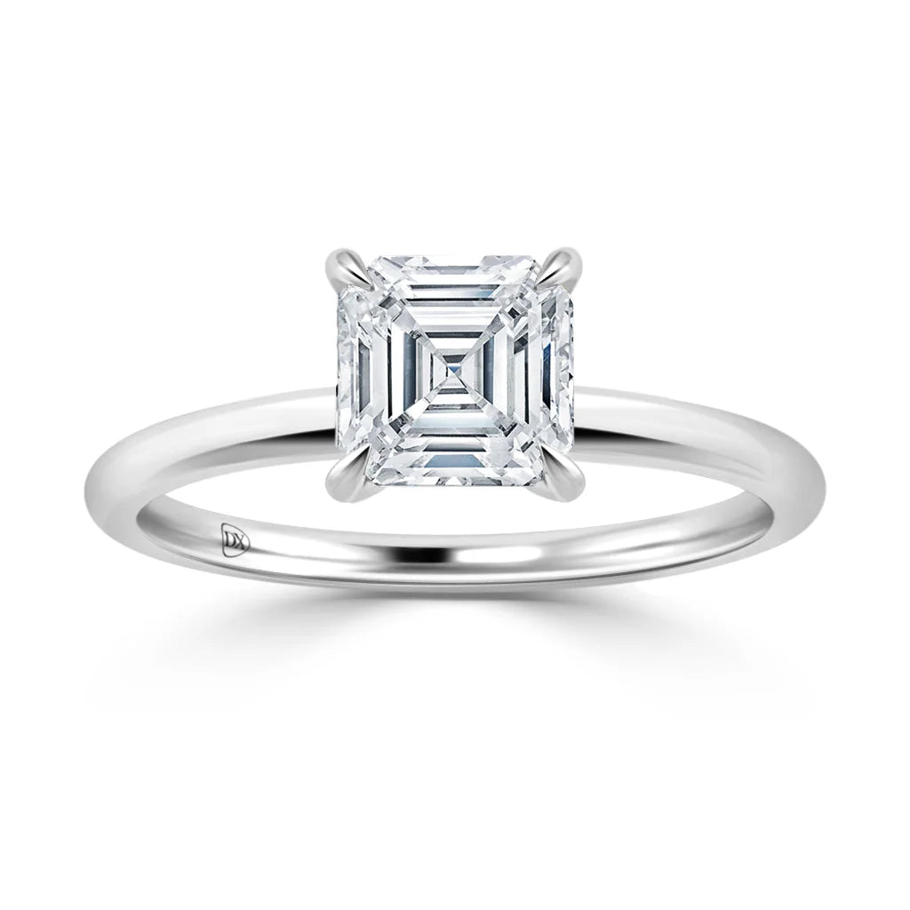 A solitaire ring with an Asscher-cut diamond set on a simple, polished white gold band.