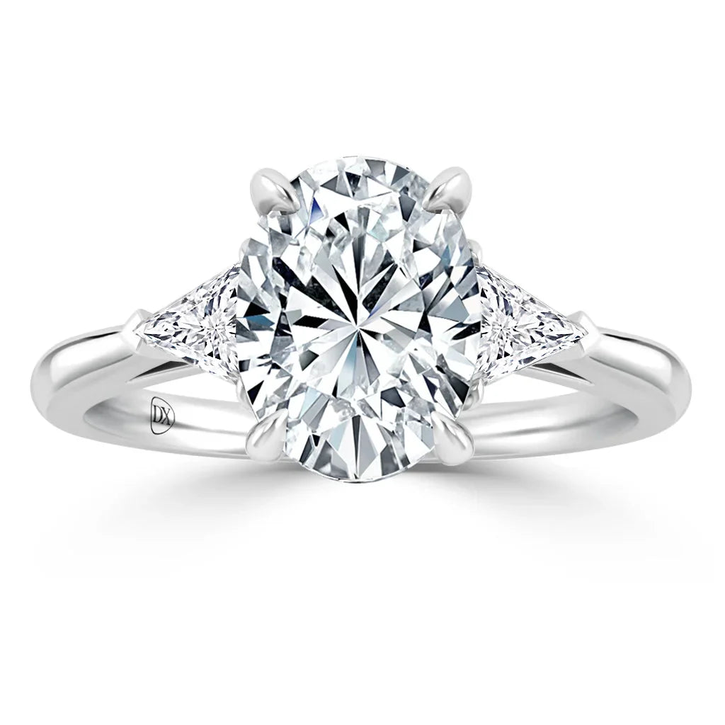 A platinum ring with a large oval diamond center and two triangular diamonds on each side.