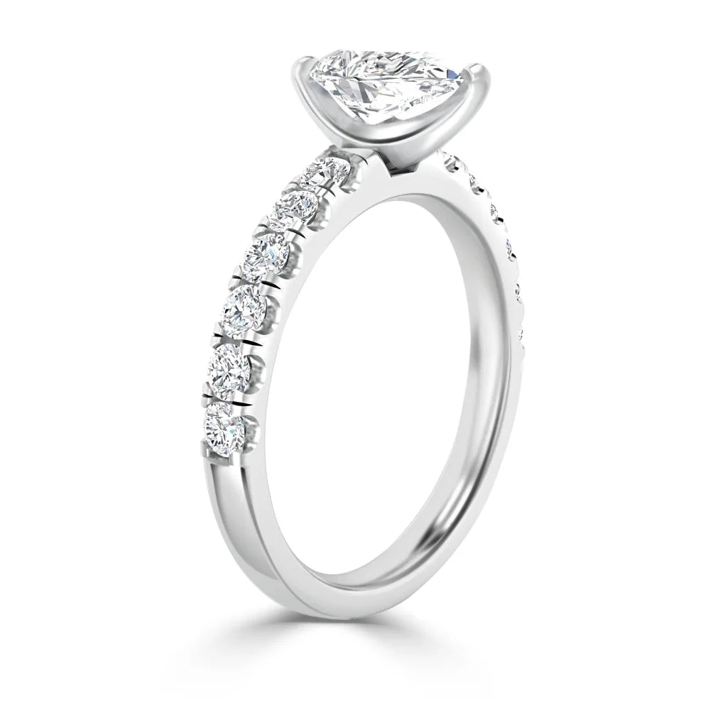 A white gold ring with a marquise-cut center diamond and small round diamonds set along the band.
