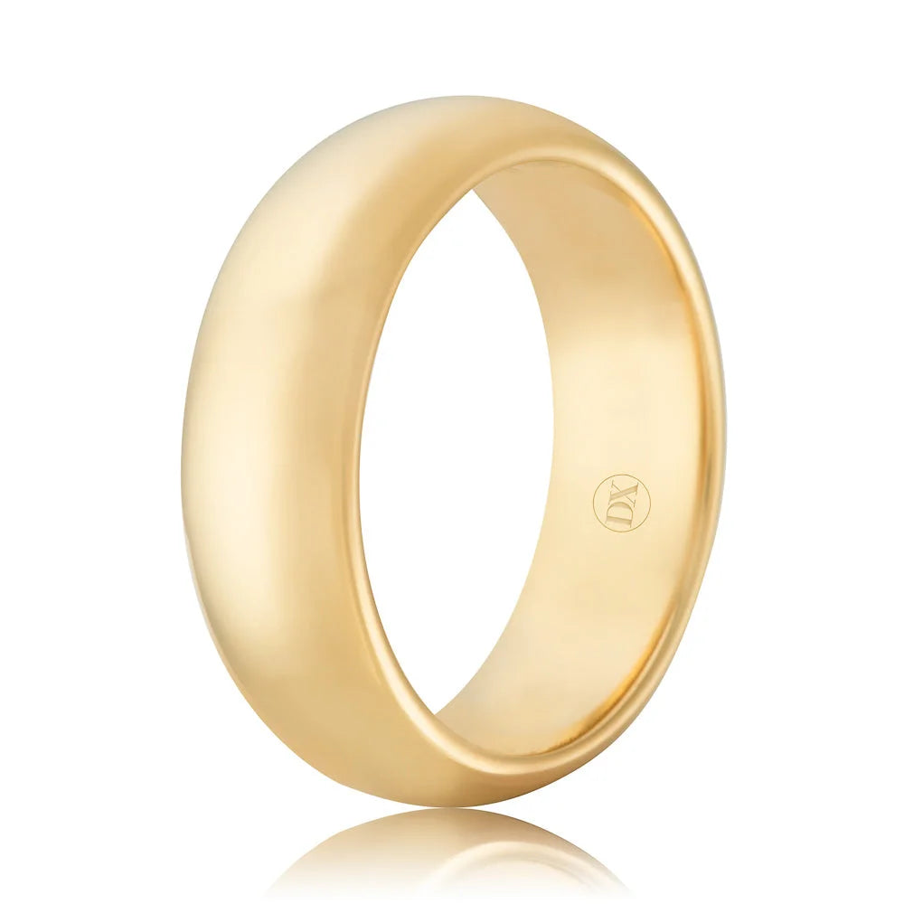 A plain, wide, polished yellow gold ring with a smooth, rounded surface and a small engraved logo inside.