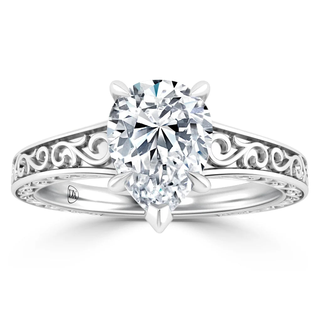 An ornate silver ring with a large oval diamond and intricate scrollwork on the band.