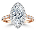 A marquise-cut diamond ring with a diamond halo and a rose gold band adorned with small round diamonds.