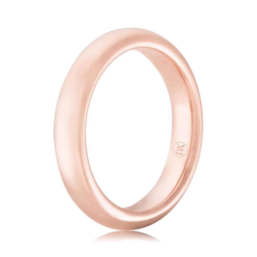 A polished rose gold band ring with a smooth, rounded surface and a small engraved logo inside.