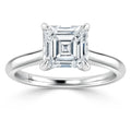 A silver ring with a large, square-cut diamond set in a classic four-prong solitaire setting.
