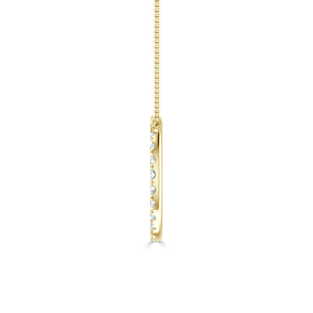 Gold necklace with a vertical, slim bar pendant set with small round diamonds, shown from the side.