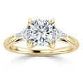 Gold ring with a round center diamond and two triangular side diamonds on a plain band, viewed from the front.