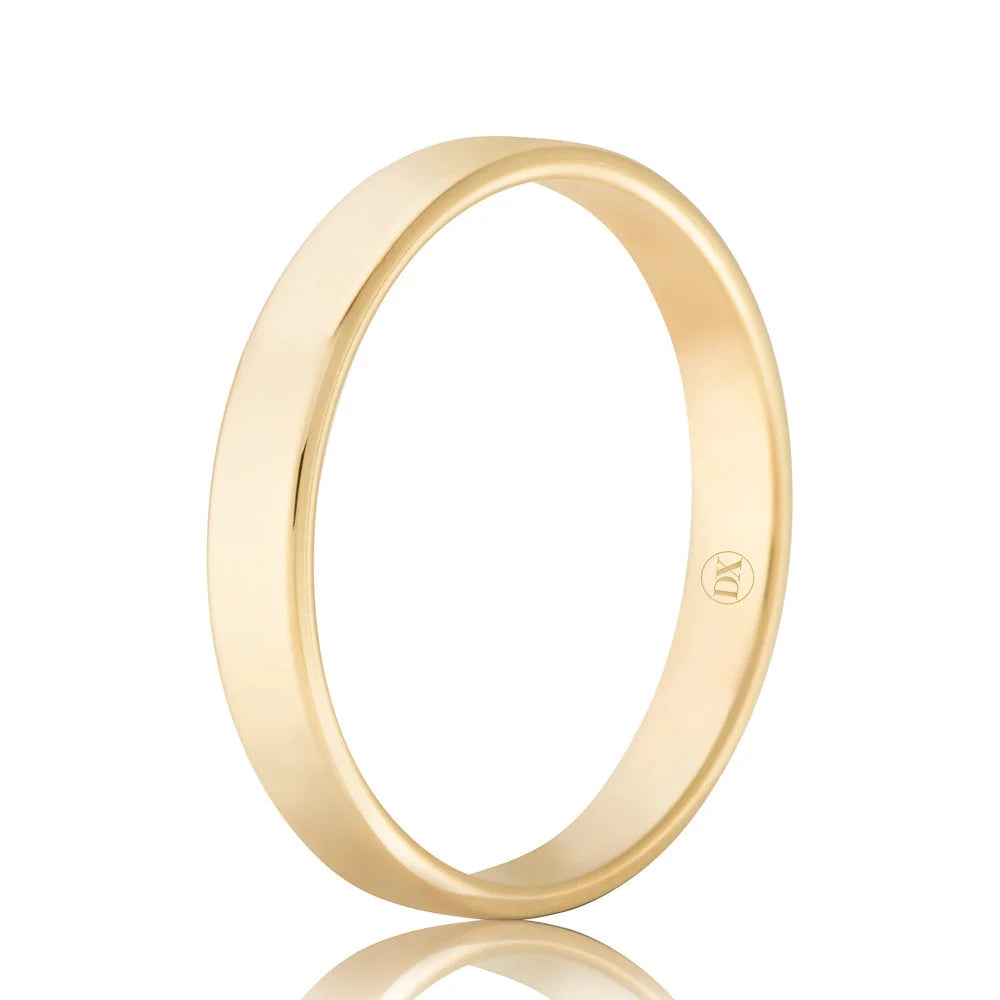 Simple gold wedding band with a smooth, polished finish and a small engraved symbol inside the band.