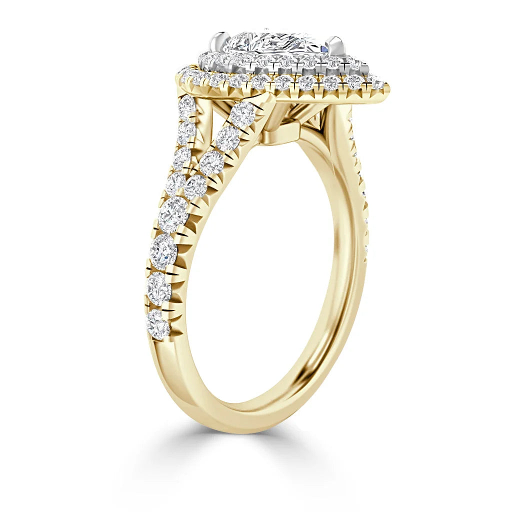 Gold engagement ring with a round diamond halo setting and pavé diamonds along the split shank band.