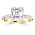 Gold ring with an Asscher-cut diamond center and round diamonds set along the band.