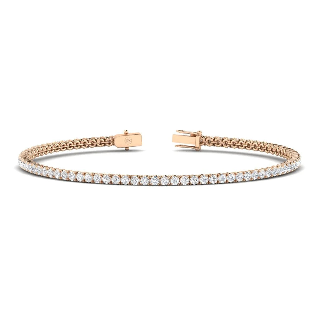 A rose gold tennis bracelet with a single row of round white diamonds and a box clasp.