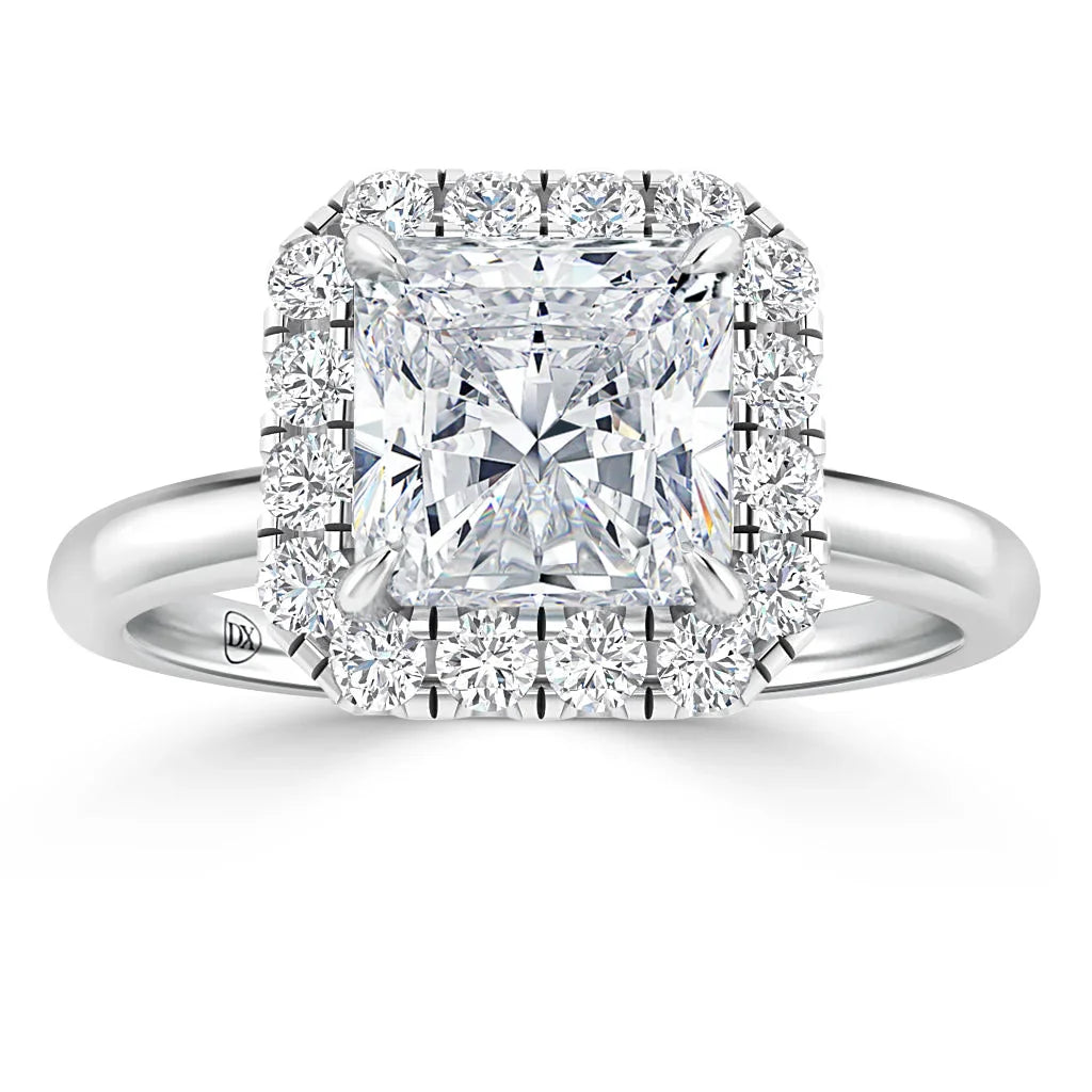 A princess-cut diamond ring with a halo of round diamonds on a polished white gold band.