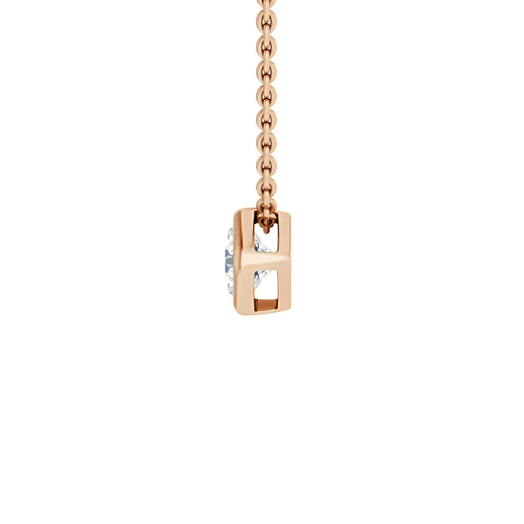 A rose gold chain necklace with a rectangular pendant holding a clear gemstone in the center.