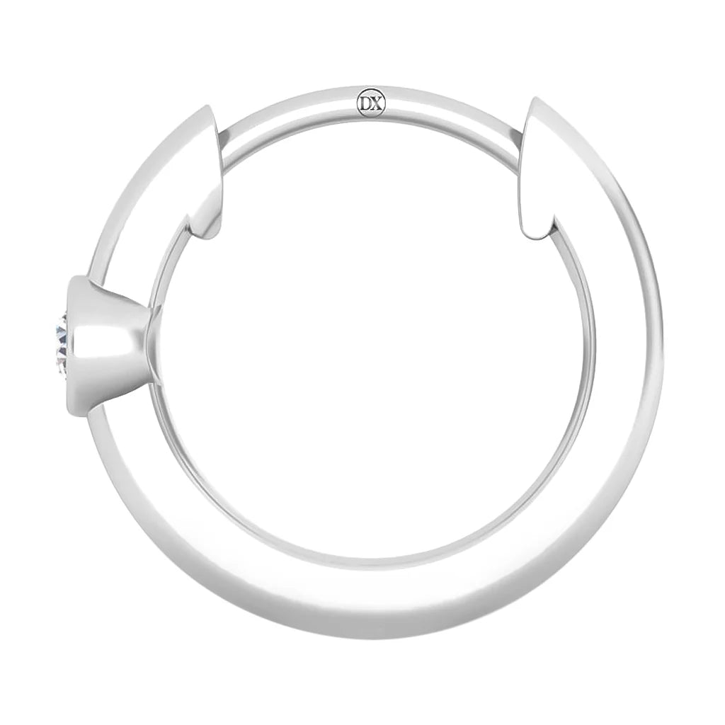 A circular silver hoop earring with a small gem set in a tapered side and a discreet clasp mechanism.