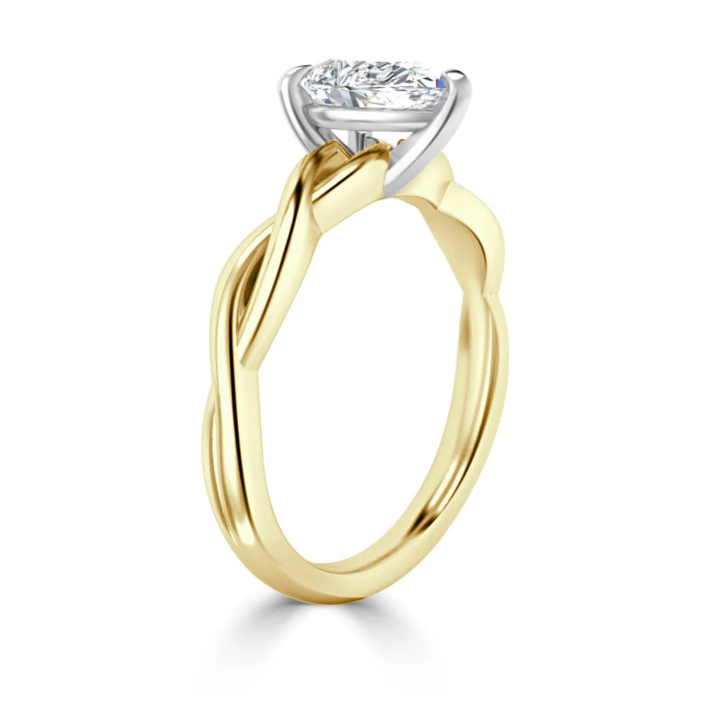 Gold ring with a twisted band and a round, prong-set diamond in a white gold setting, side view.