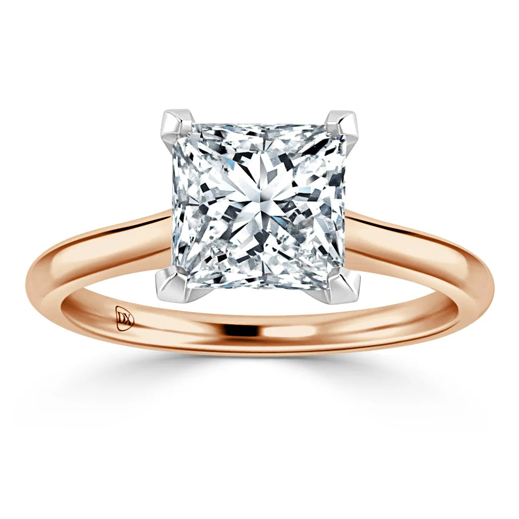 Rose gold ring with a large square-cut diamond in a four-prong setting, shown on a white background.
