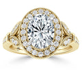 Gold ring with an oval diamond center and double diamond halo, featuring intricate side detailing.