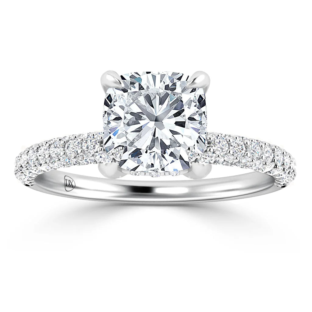 A cushion-cut diamond ring with a pavé diamond band set in white gold, shown against a white background.