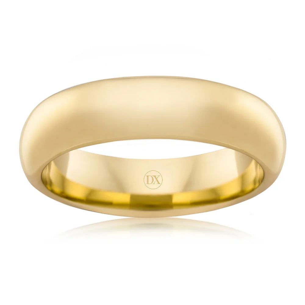 A simple, polished yellow gold ring with a smooth, rounded band and DX engraved inside.