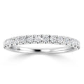 White gold band ring with a row of round diamonds set along the top half of the band.