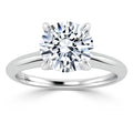 A solitaire engagement ring with a round, brilliant-cut diamond on a plain white gold band.
