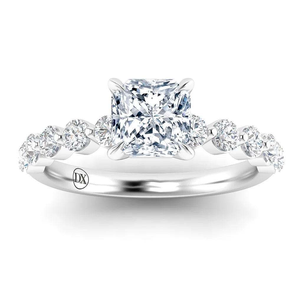 A platinum ring with a princess-cut diamond center and round diamonds along the band.