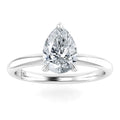 A pear-shaped diamond solitaire ring with a slim, polished white metal band on a white background.