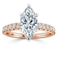 A marquise-cut diamond ring with a rose gold band accented by small round diamonds, shown on a white background.