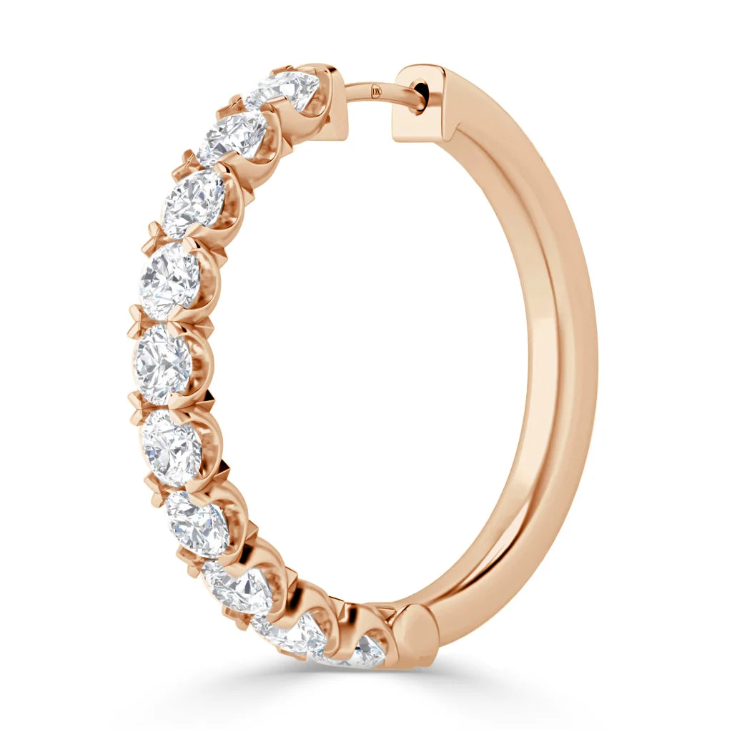 Rose gold hoop earring with a row of round, white diamonds set along the outer edge.
