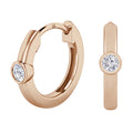 Rose gold hoop earrings with a single round diamond set in a bezel on each earring, shown from two angles.