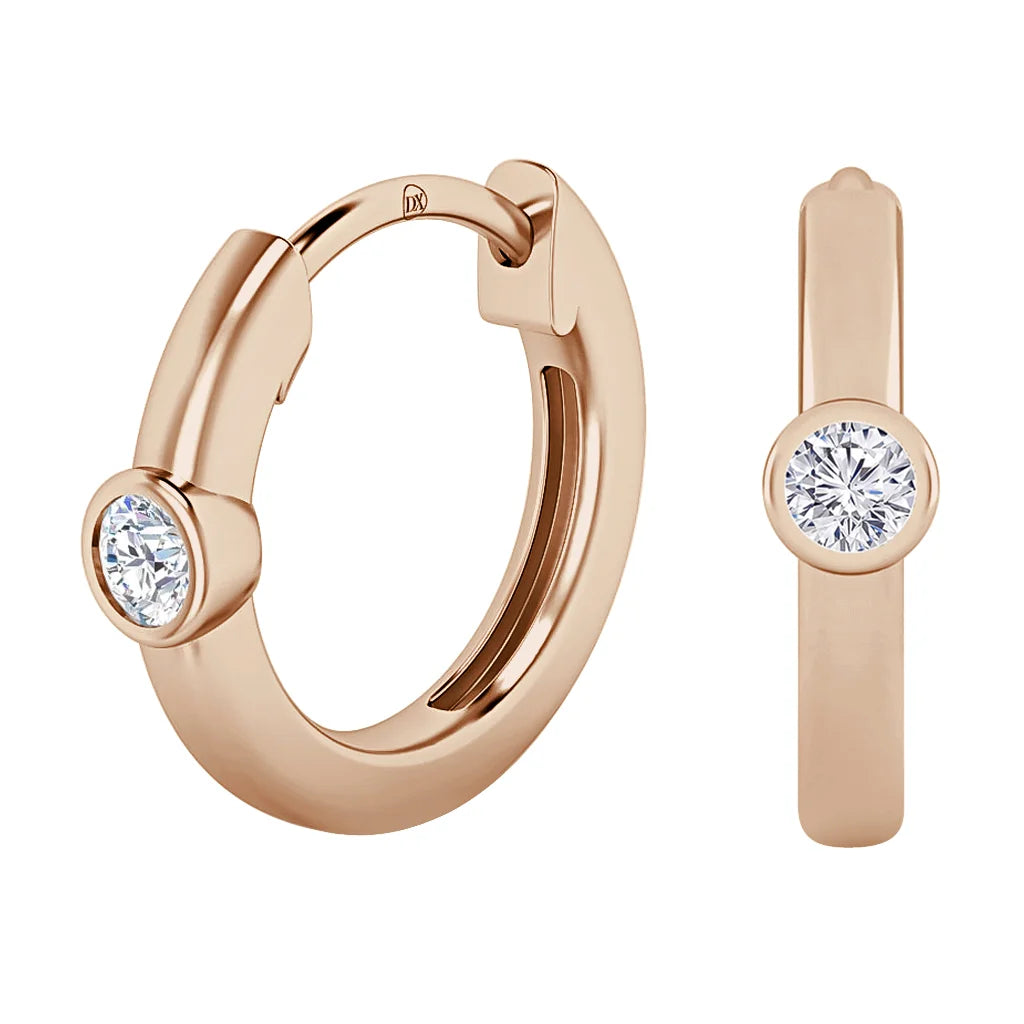 Rose gold hoop earrings with a single round diamond set in a bezel on each earring, shown from two angles.