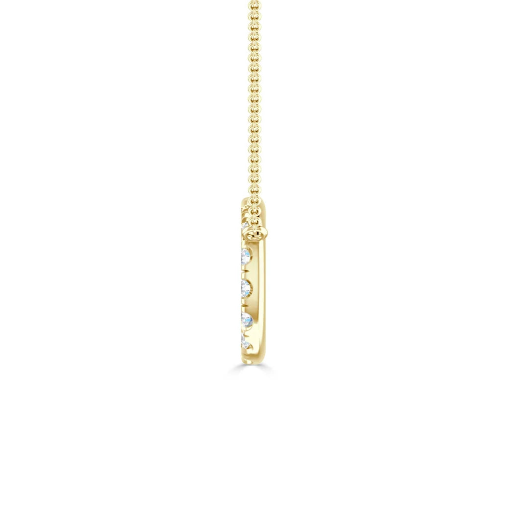 Side view of a gold pendant necklace with embedded small round diamonds on a delicate gold chain.