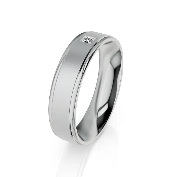 Silver band ring with a single small diamond set in a flat, brushed surface, shown on a white background.