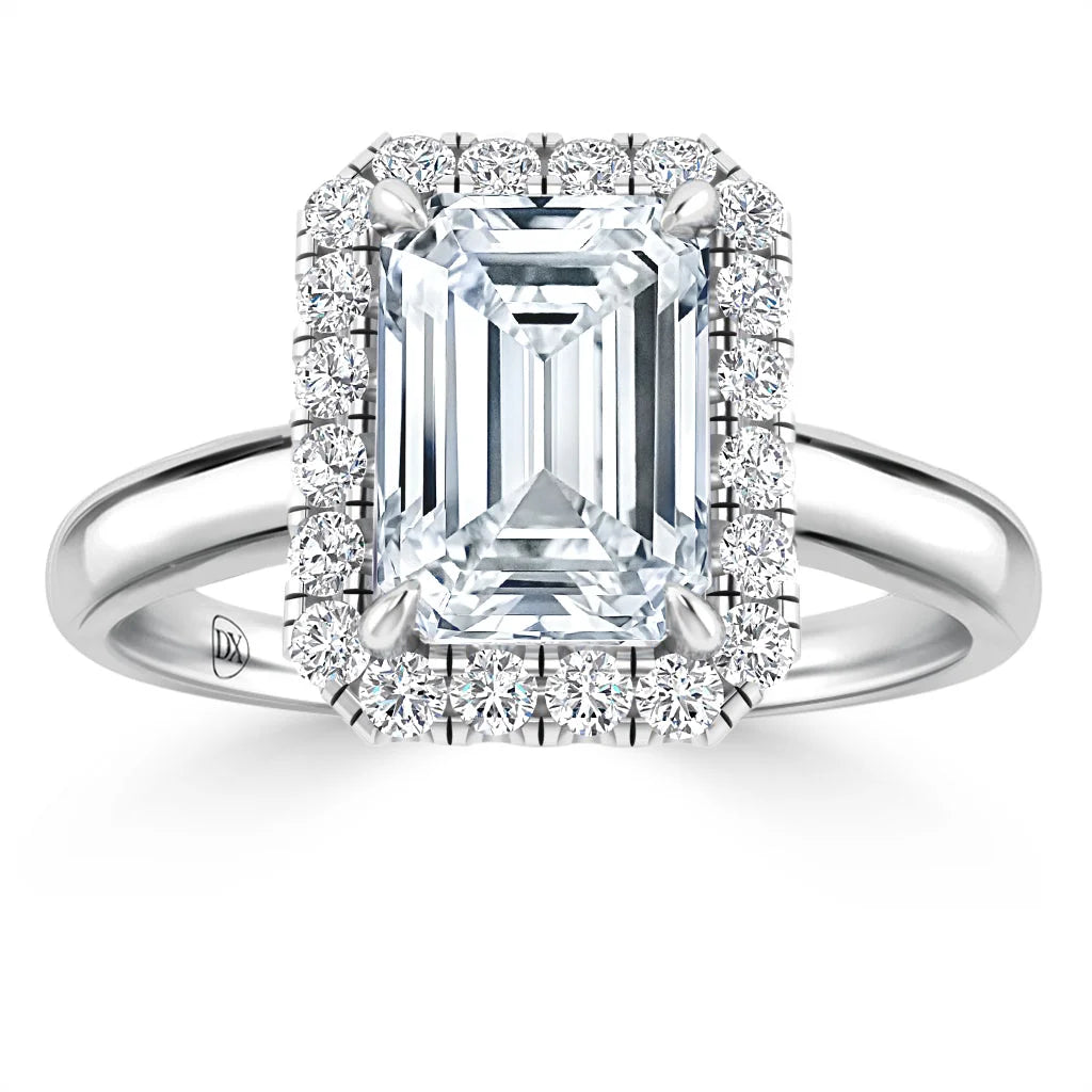 A platinum ring with a large emerald-cut diamond, surrounded by a halo of round diamonds.