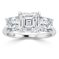 Platinum ring with three square-cut diamonds, the center stone larger than the two on each side.
