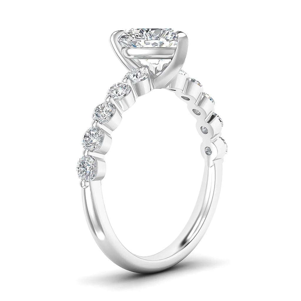 White gold ring with round-cut diamonds on the band and a large solitaire diamond in a prong setting.