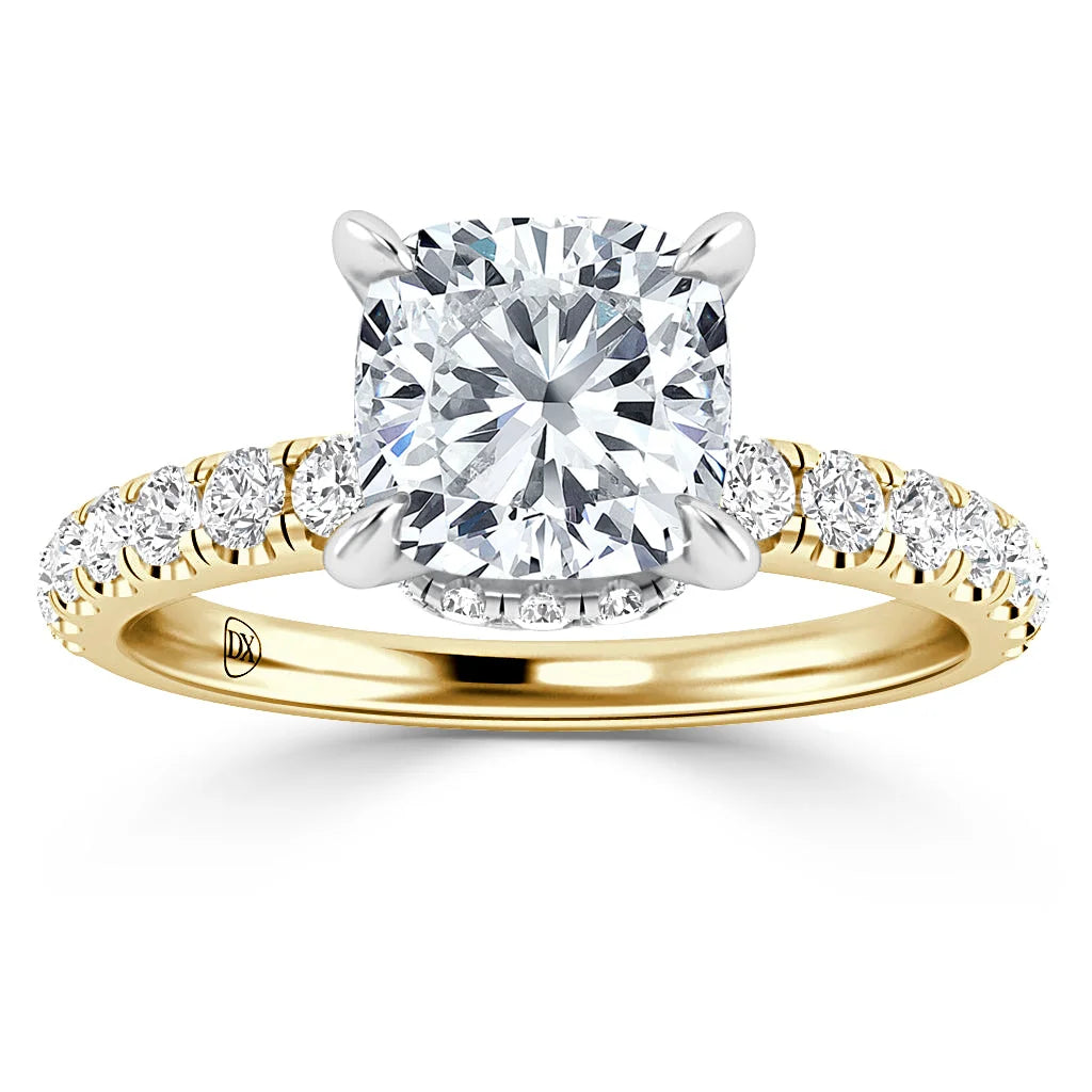 Gold ring with a large cushion-cut diamond center and smaller diamonds along the band.