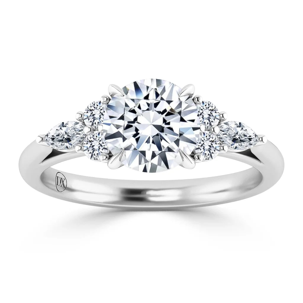 A white gold ring with a large round center diamond, flanked by two smaller round diamonds on each side.