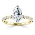 Gold ring with a marquise-cut diamond center and small round diamonds set along the band.