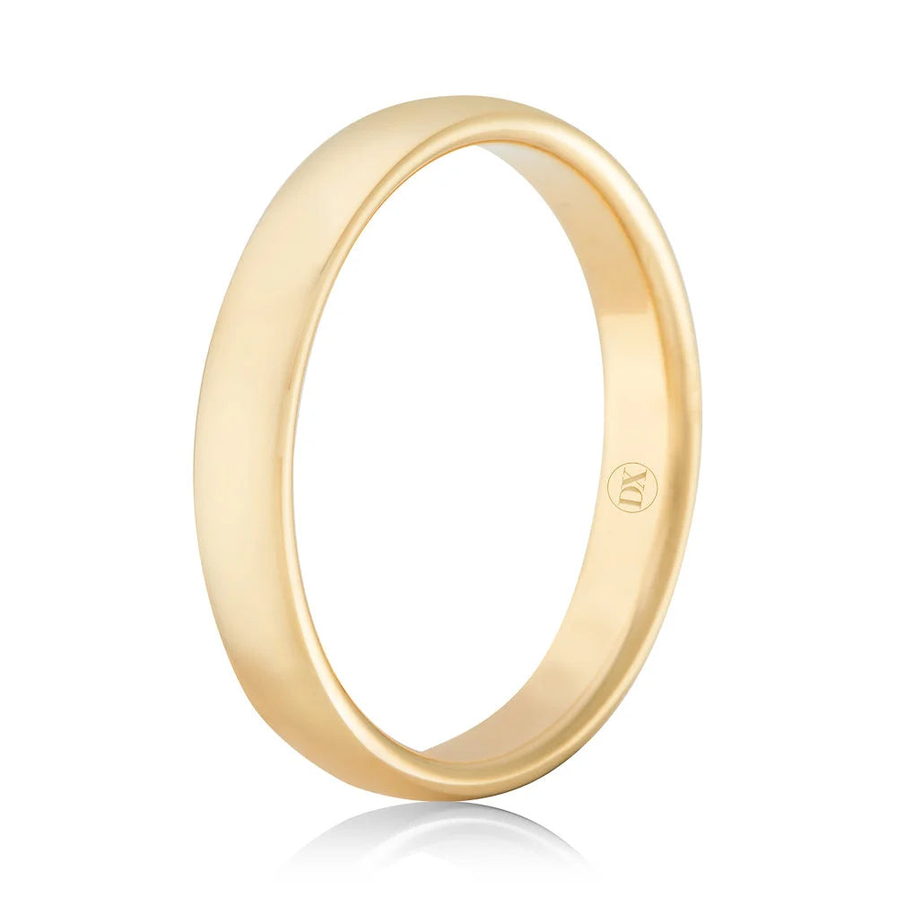 A simple, polished yellow gold ring with a smooth surface and a small logo engraved inside the band.